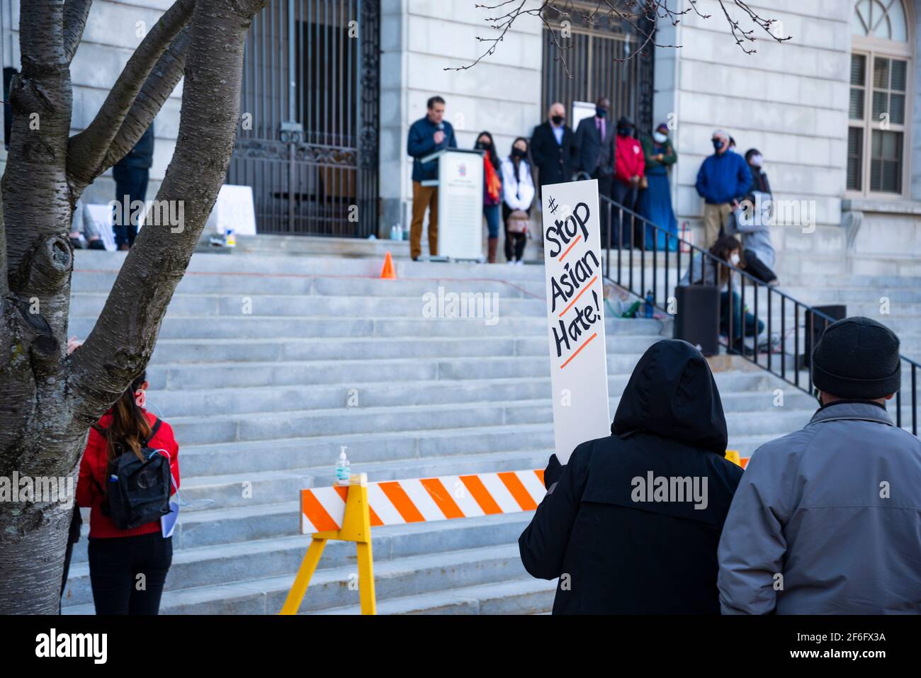 People holding signs supporting Asians in order to protest against the white supremacy in Portland Maine Stock Photo
