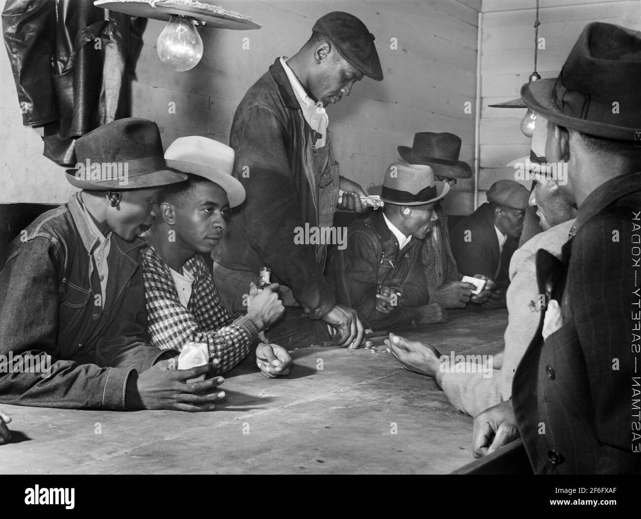 Men spending their money in Gambling and Juke Joint, Saturday night, outside Clarksdale, Mississippi, USA, Marion Post Wolcott, U.S. Farm Security Administration, November 1939 Stock Photo