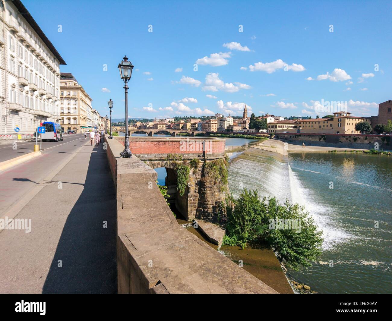 View on Florence city center from river embankment. River Arno cascade. Travel Italy Stock Photo