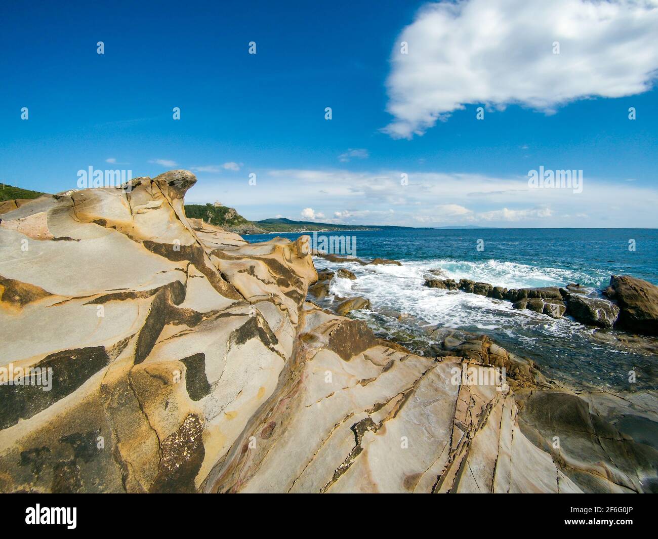 Calignaia wild rocky coast near Castello Sonnino, near Livorno city in Italy. Summer mediterranean sea. Bright day with blue sky, beautiful natural su Stock Photo