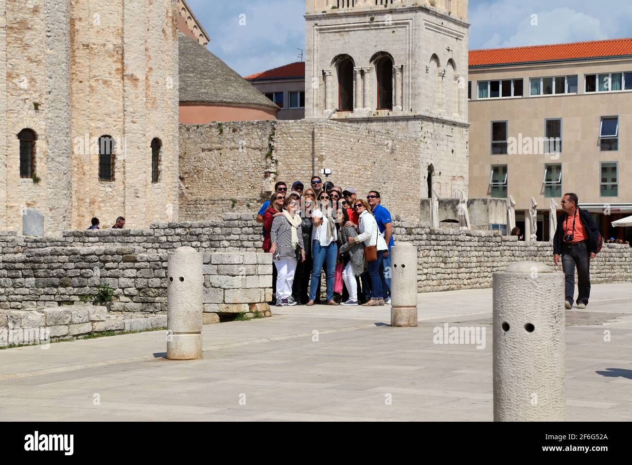 Group of tourists taking a selfie outside the Church of St Donatus, Zadar Croatia Stock Photo