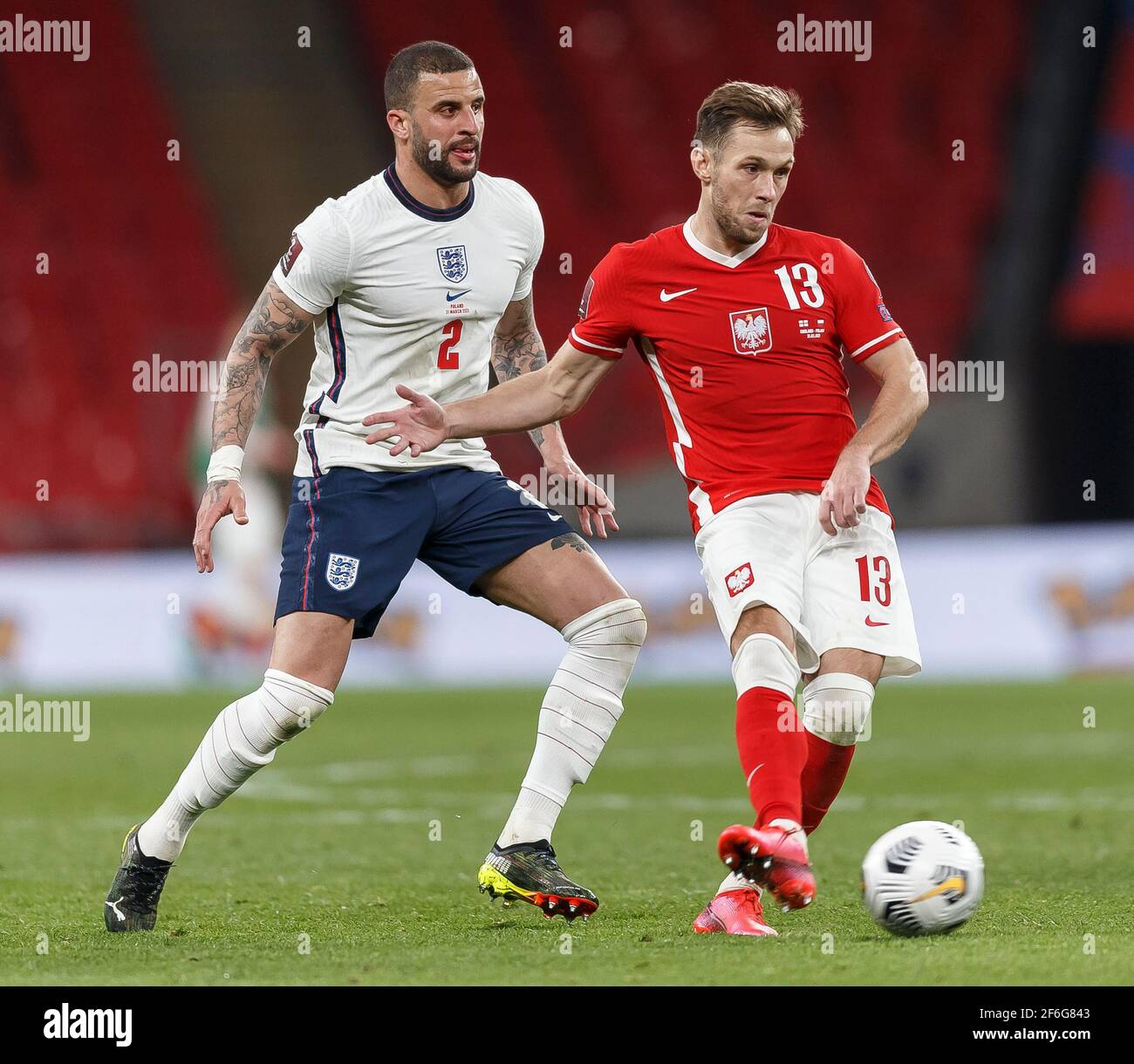 London, UK. 31st Mar, 2021. Kyle Walker of England and Maciej Rybus of Poland during the FIFA World Cup 2022 Qualifying Group I match between England and Poland at Wembley Stadium on March 31st 2021 in London, England. (Photo by Daniel Chesterton/phcimages.com) Credit: PHC Images/Alamy Live News Stock Photo