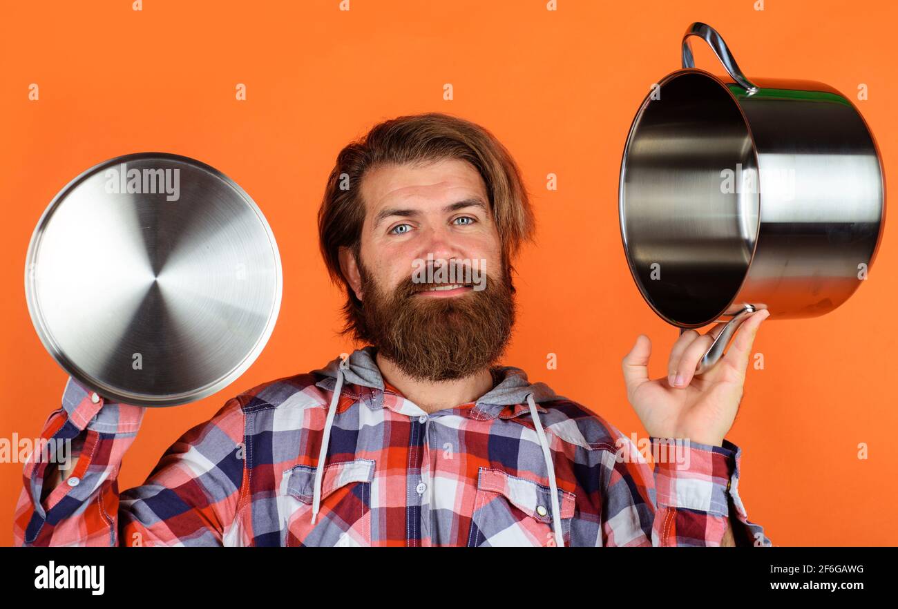 Kitchenware. Cooking utensils. Man with saucepan. Happy chef with cooking  pot. Kitchen advertising Stock Photo - Alamy