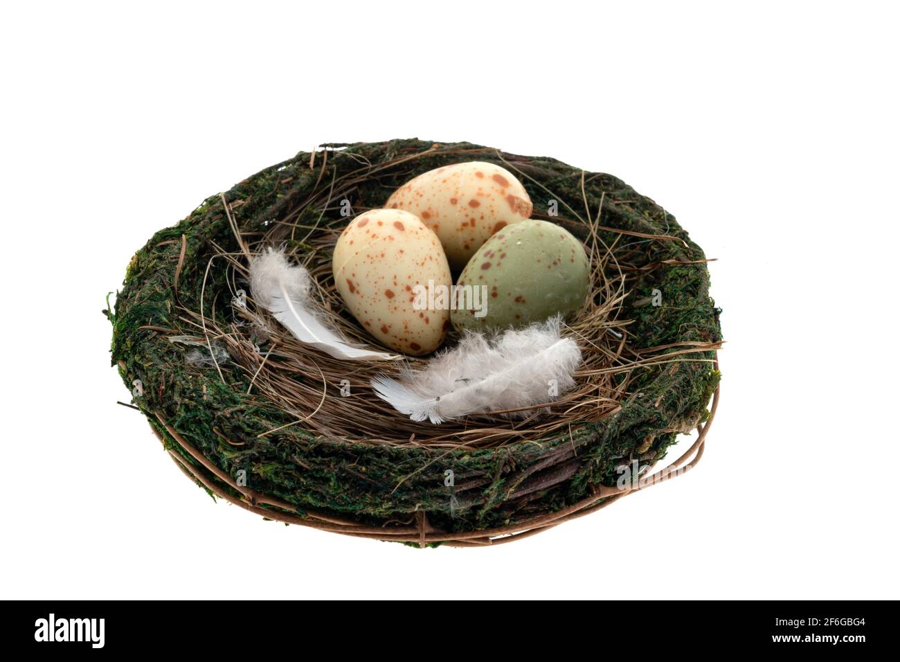 Three chocolate Easter eggs in a birds nest - white background Stock Photo