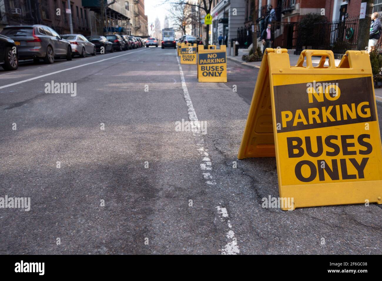 Yellow black sandwitch board with text that reads No parking buses only Stock Photo