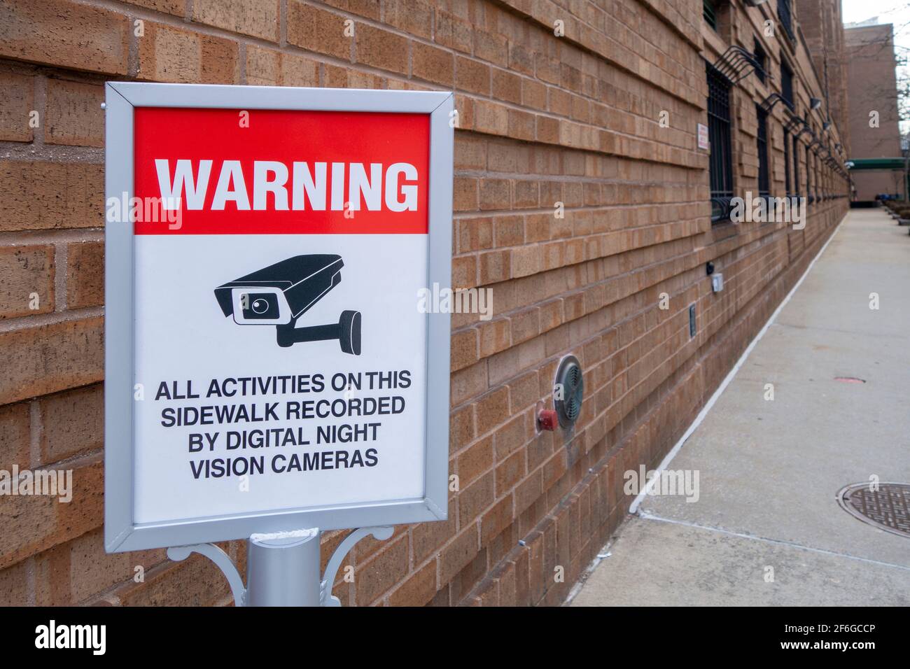 Private security cameras warning notice  sign warning All activities on this sidewalk recorded by digital night vision cameras Stock Photo