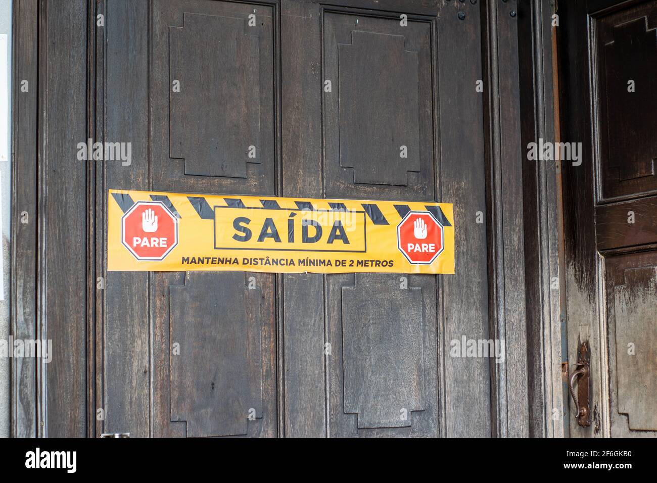 Church Exit door sticker in portuguese churches in times of coronavirus, keep two meters distance stickers Stock Photo