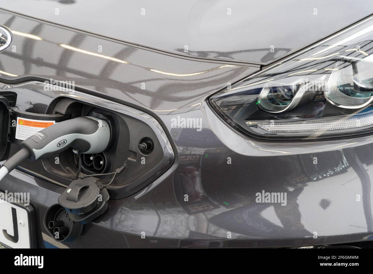 KIA electric car charging cable plugs in power source Stock Photo Alamy