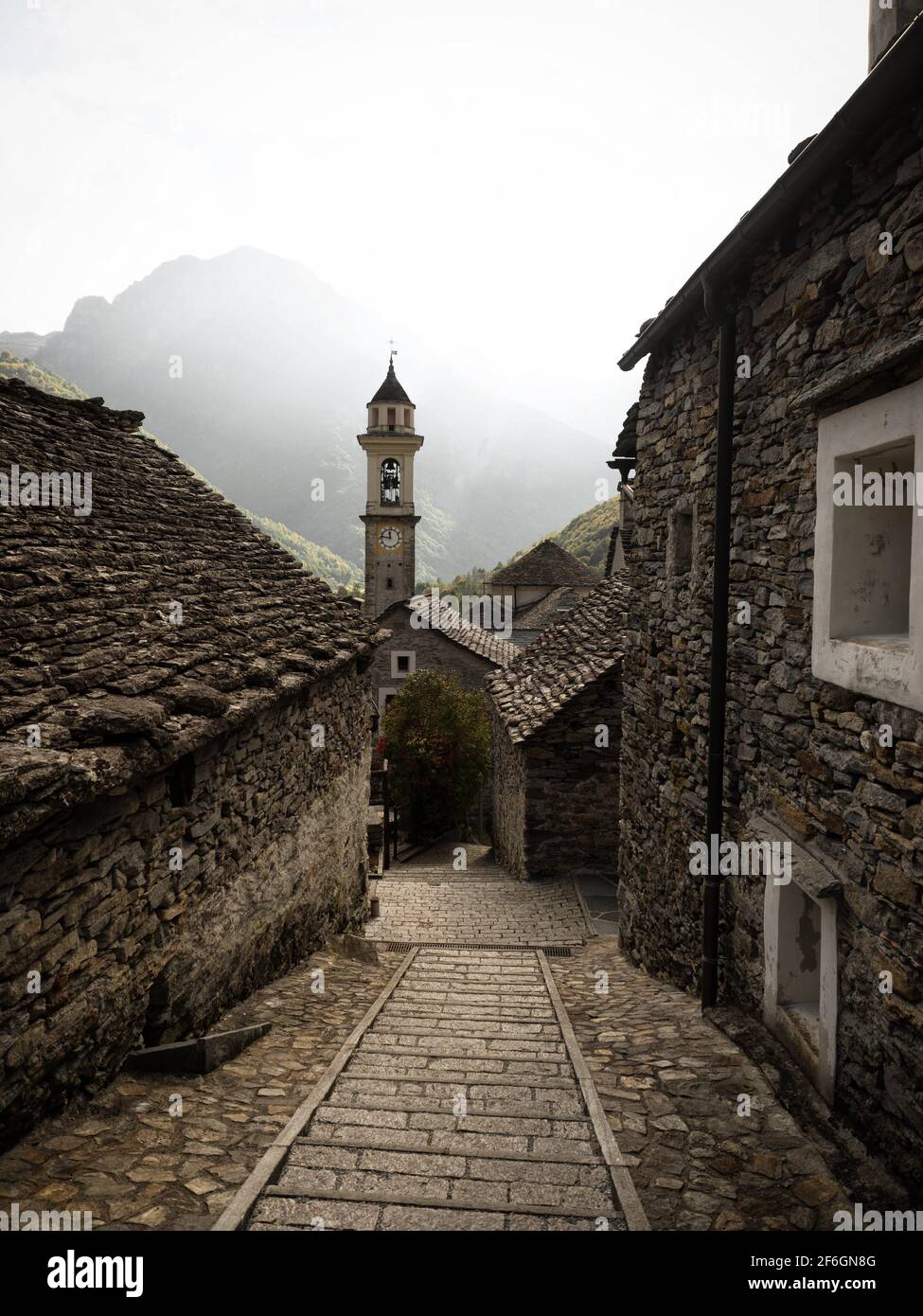 Panorama view of old historic traditional schist stone rock building church clock bell tower in picturesque quaint charming village Sonogno Verzasca V Stock Photo