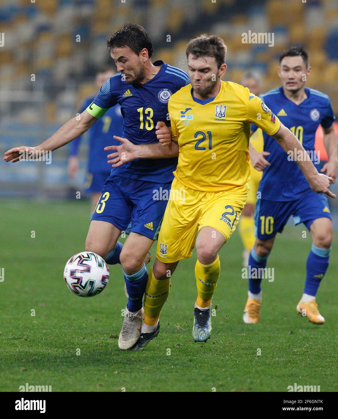 Ukraine's Oleksandr Karavayev (R), in and Kazakhstan`s Azat Nurgaliyev (L)  are seen in action during the World Cup 2022 group D qualifying football  match between Ukraine and Kazakhstan at the Olimpiyskiy stadium.(Final