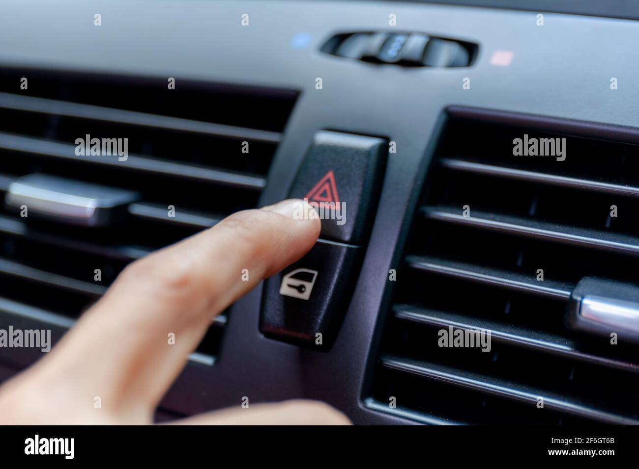 Close up hand press the emergency light in the car, Fingers press button.for  open the contract emergency light in car. Emergency button press for open  Stock Photo - Alamy