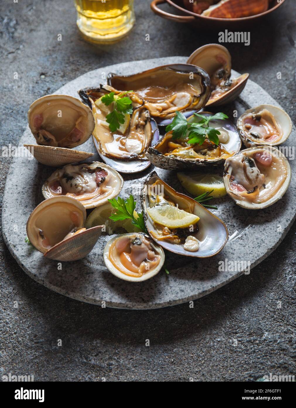 Fresh seafood shellfish mussels, clams, crabs and snails on gray