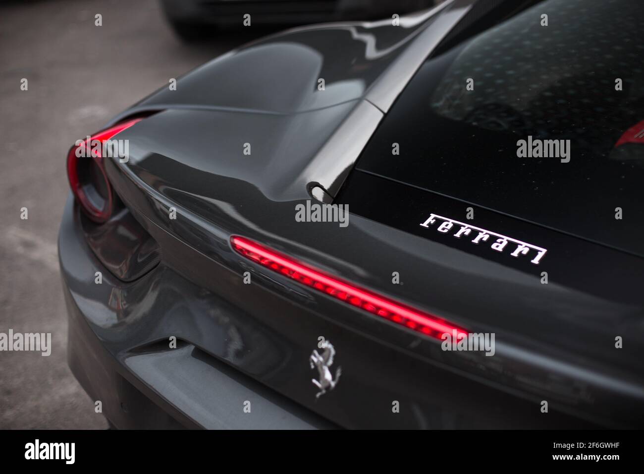 The Ferrari Logo On The Engine Cover On The Rear Of A Grey And Black 2016 Ferrari 488 GTB Stock Photo