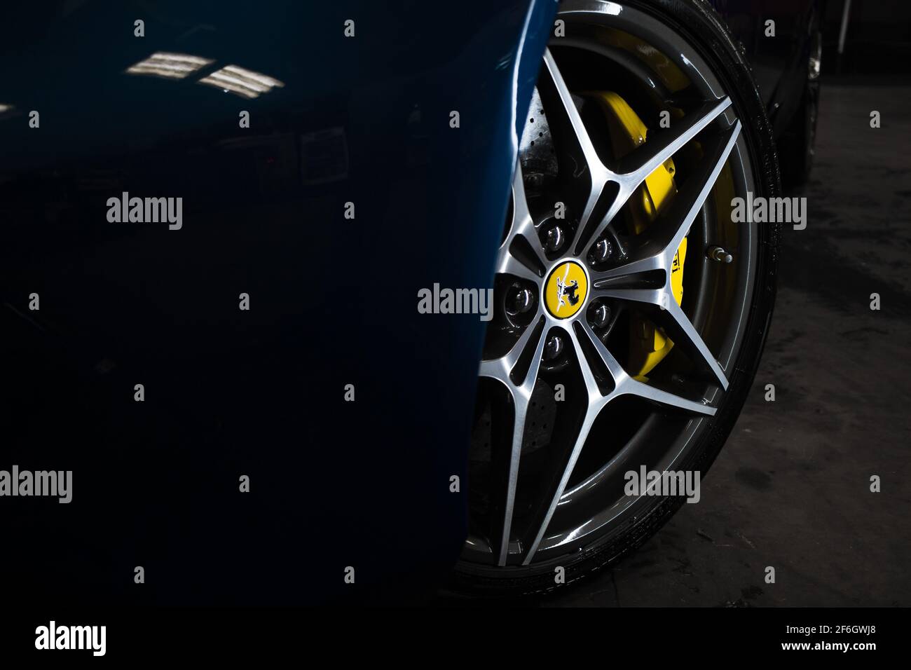 The Front Diamond Cut Wheel On A Metallic Blue 2016 Ferrari California T With Yellow Brake Callipers Stock Photo