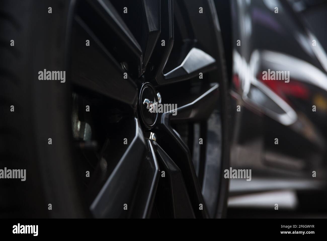The Rear Gloss Black Wheel With Mustang Badge On A 2017 Ford Mustang Eco Boost Stock Photo
