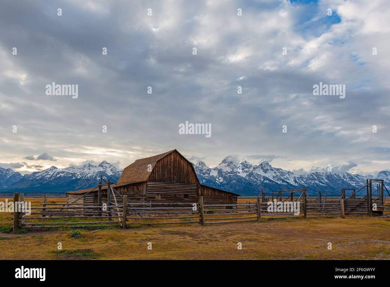 T. A. Moulton barn at sunset and Grand Teton range with snow in autumn, Grand Teton national park, Wyoming, United States of America (USA). Stock Photo