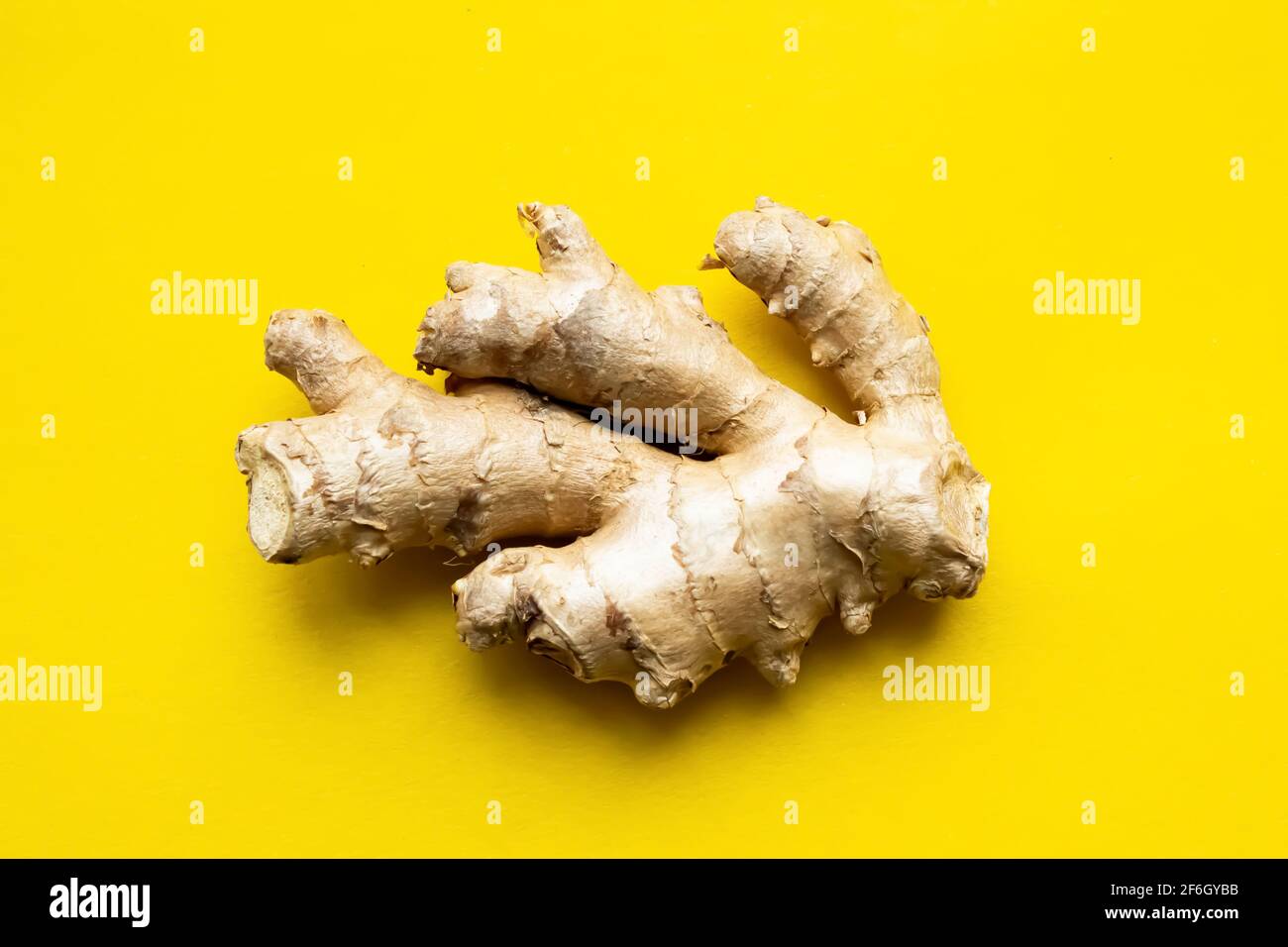 Ginger root on a yellow background. Gingerbread on an isolated