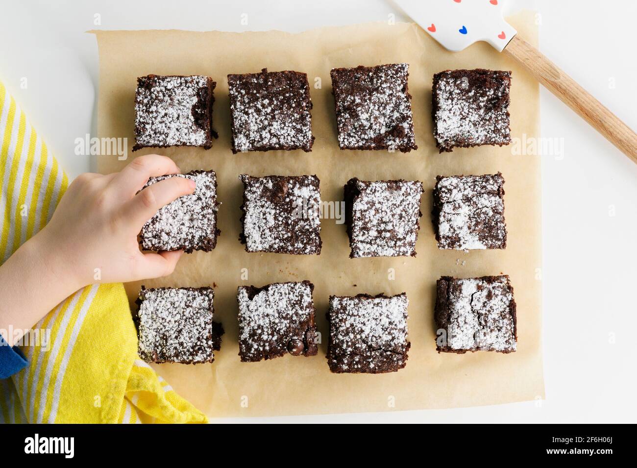 Overhead view of boys (6-7) hand reaching for freshly baked brownie Stock Photo