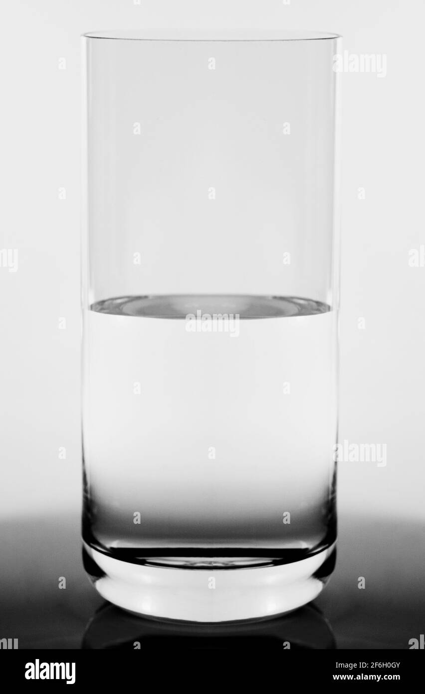 Studio shot of glass half full concept Stock Photo Alamy