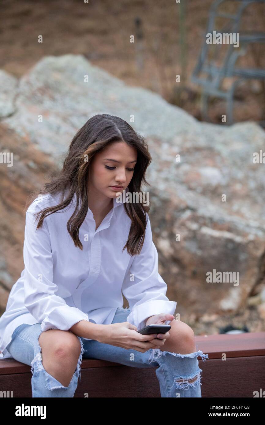 Teenage (14-15) girl using mobile phone Stock Photo