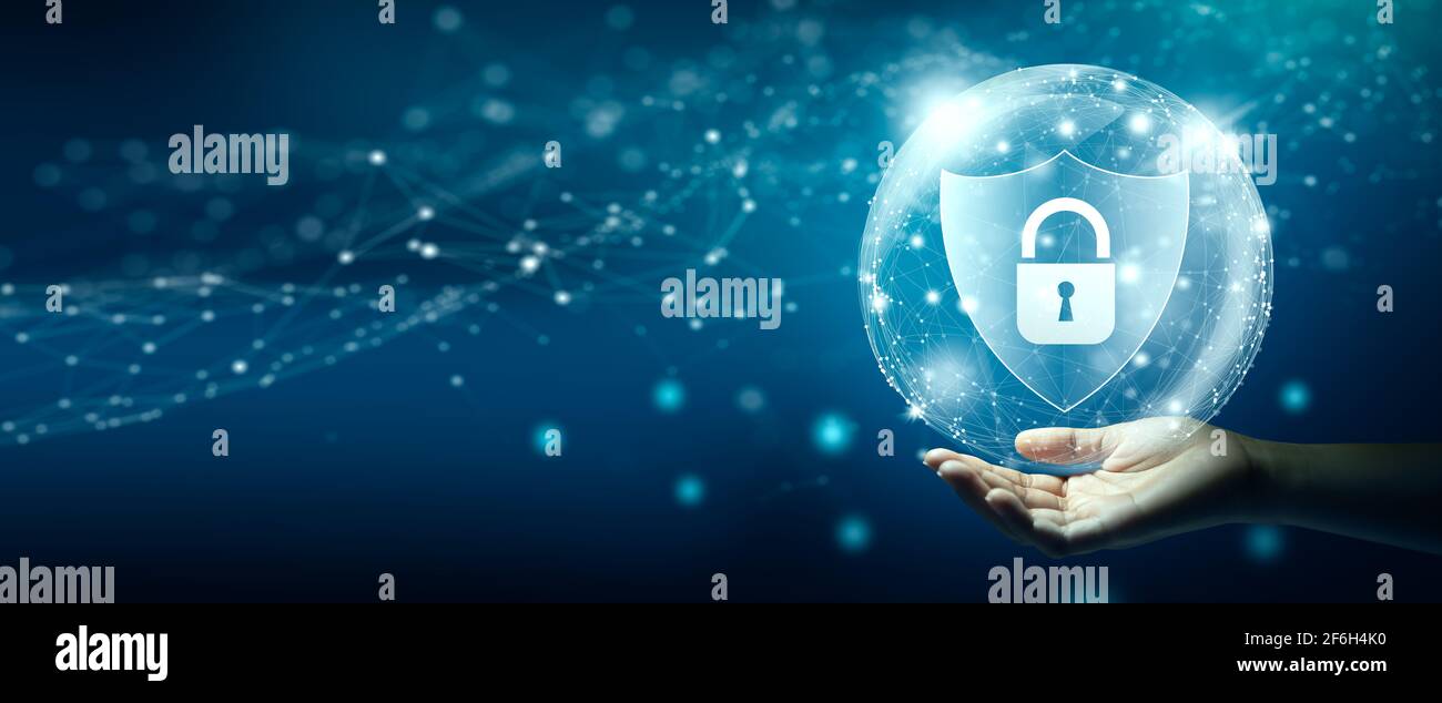 Hand holding Shield with Padlock icon and Network wireframe over blue background abstract. Cyber attack block, Cyber data, and Information privacy. Stock Photo
