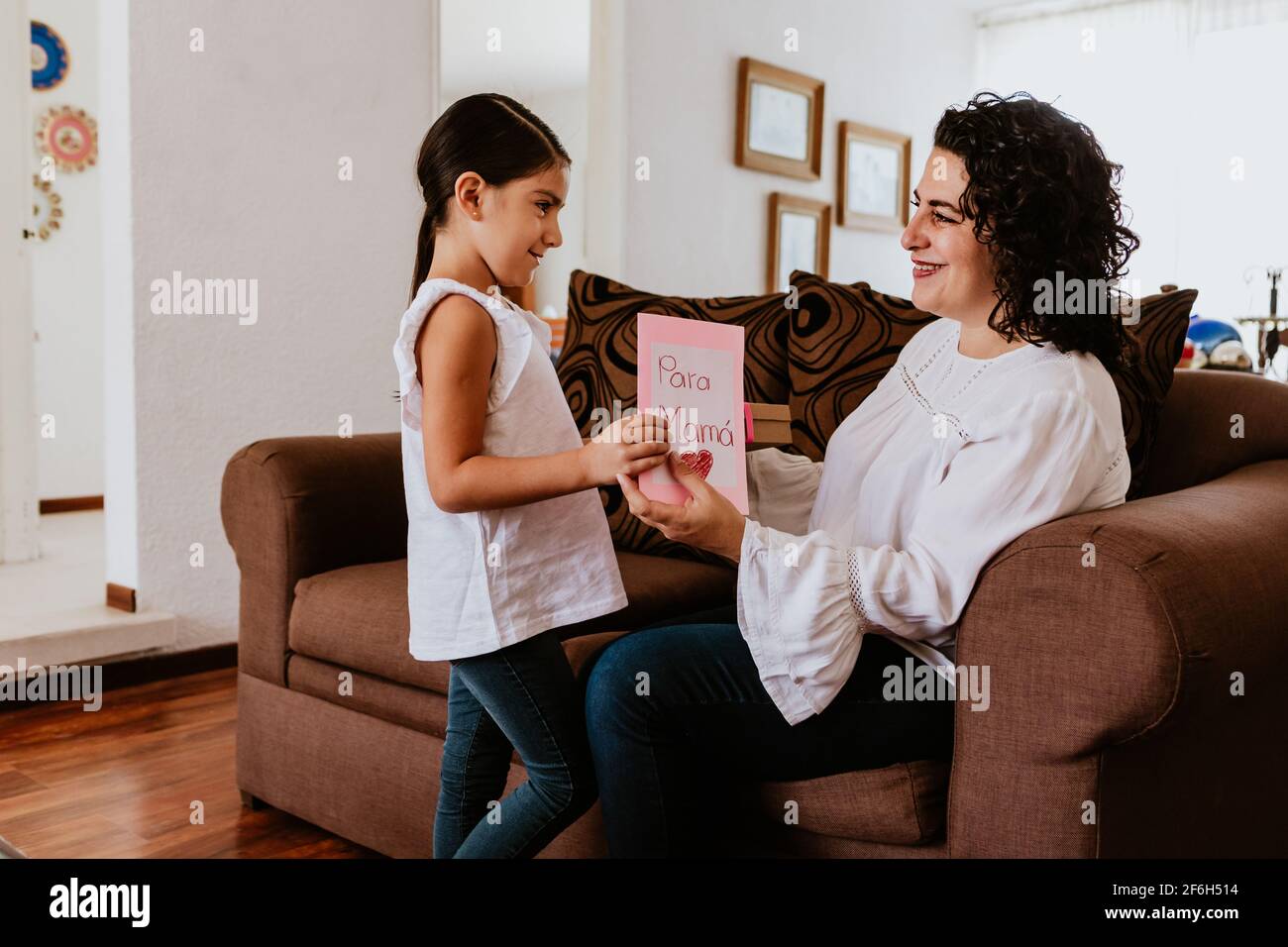 Happy mother's day, Mexican Child daughter congratulates mom and gives
