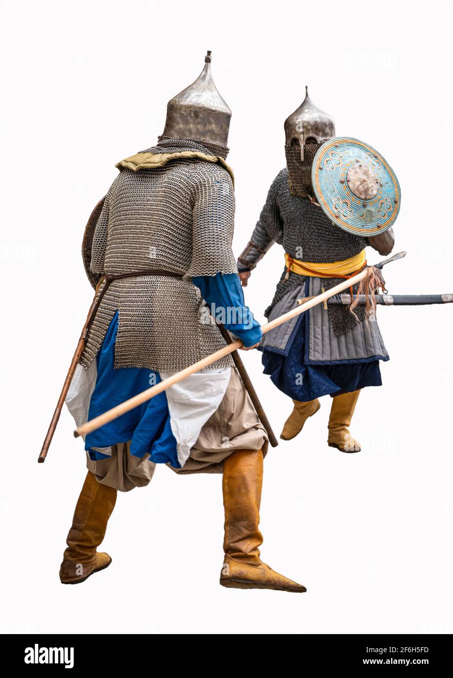 Two soldiers competing in a war with motion blurred. White background. Ancient Turkish metal and leather armor. Stock Photo