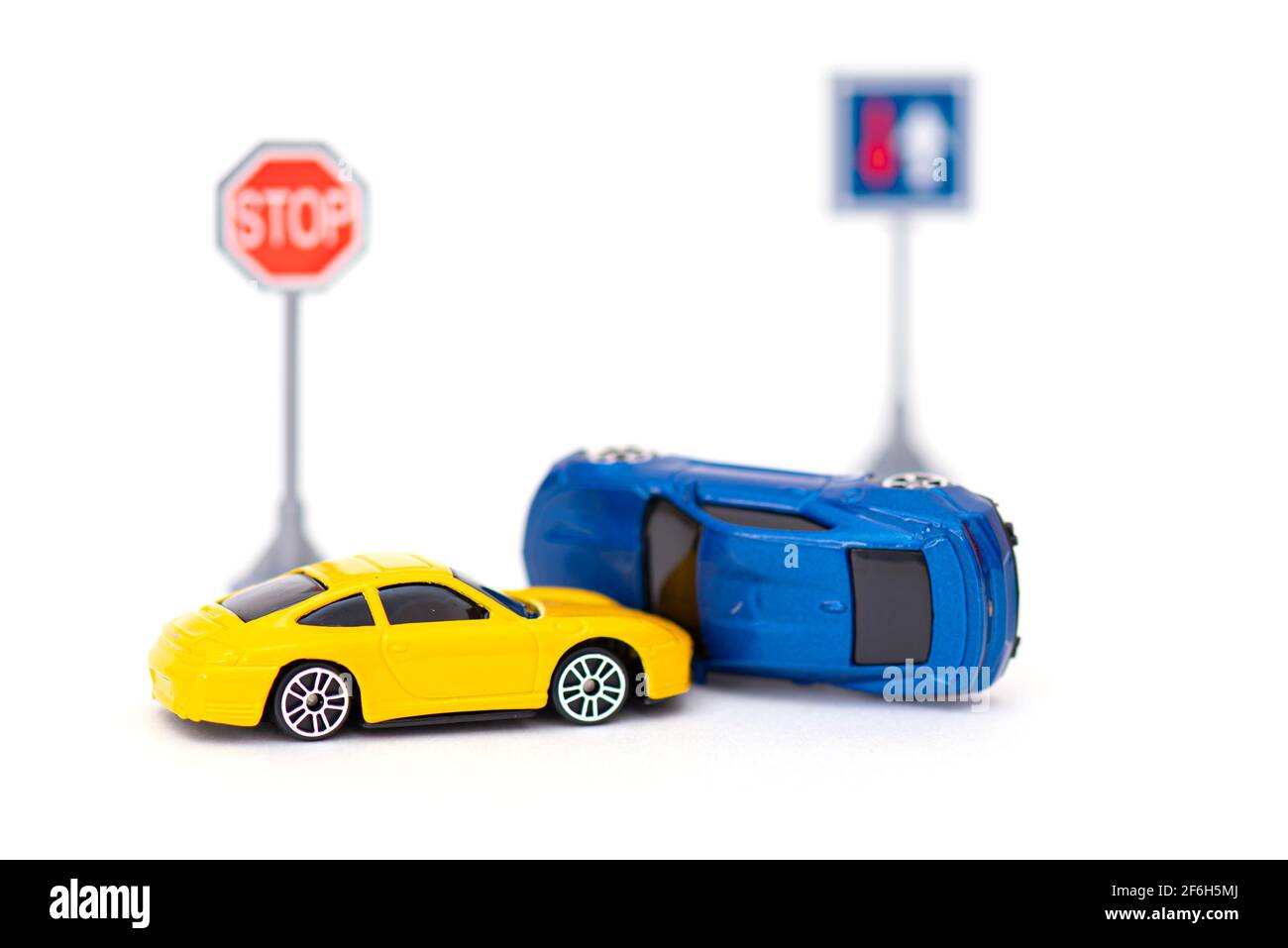 Accident with two toy cars and sign stop isolated on white. Concept picture about accident on the road Stock Photo