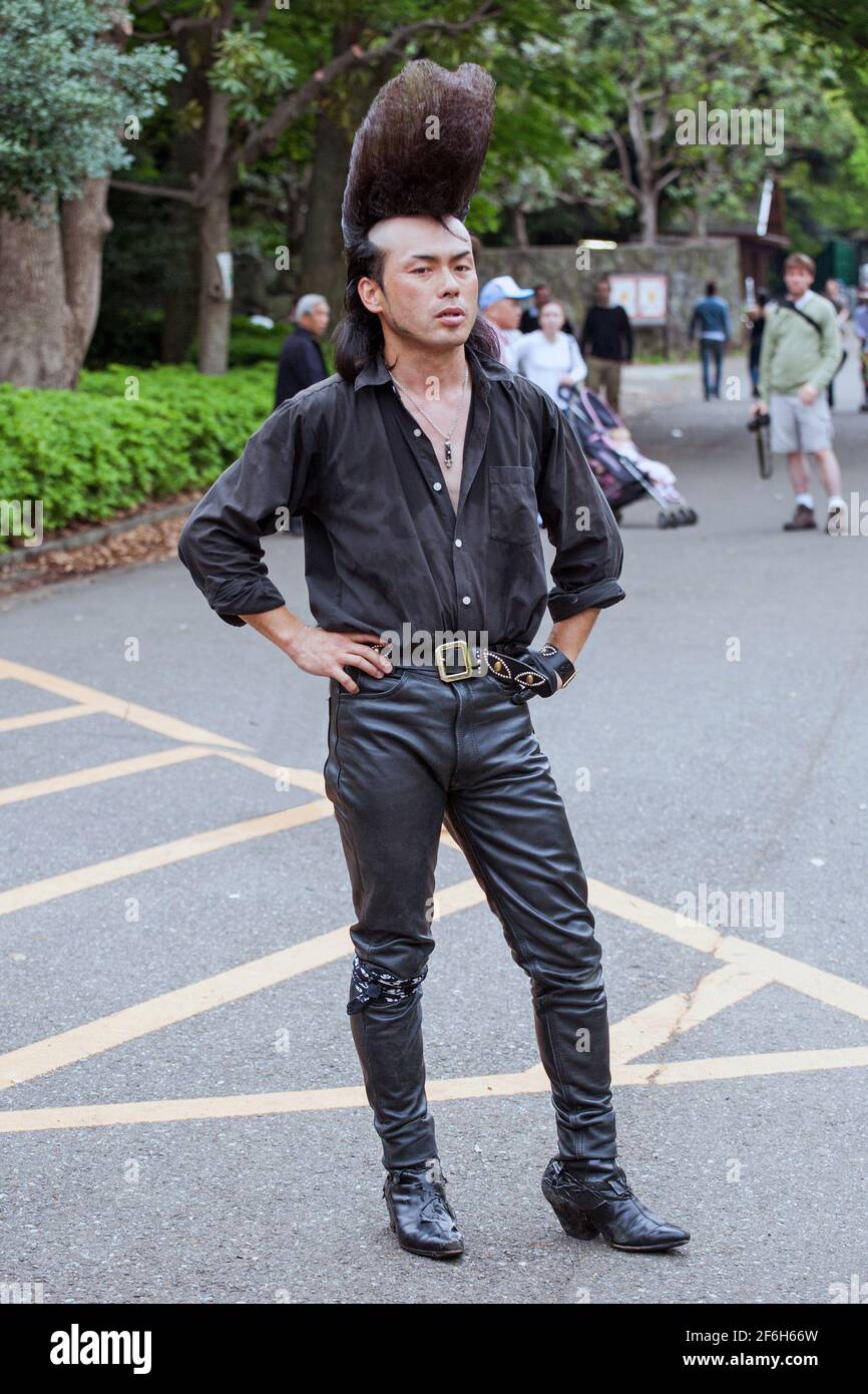Close up of Rockabilly in leather pants with huge quiff/pompadour posing in Yoyogi Park, Harajuku, Tokyo, Japan Stock Photo