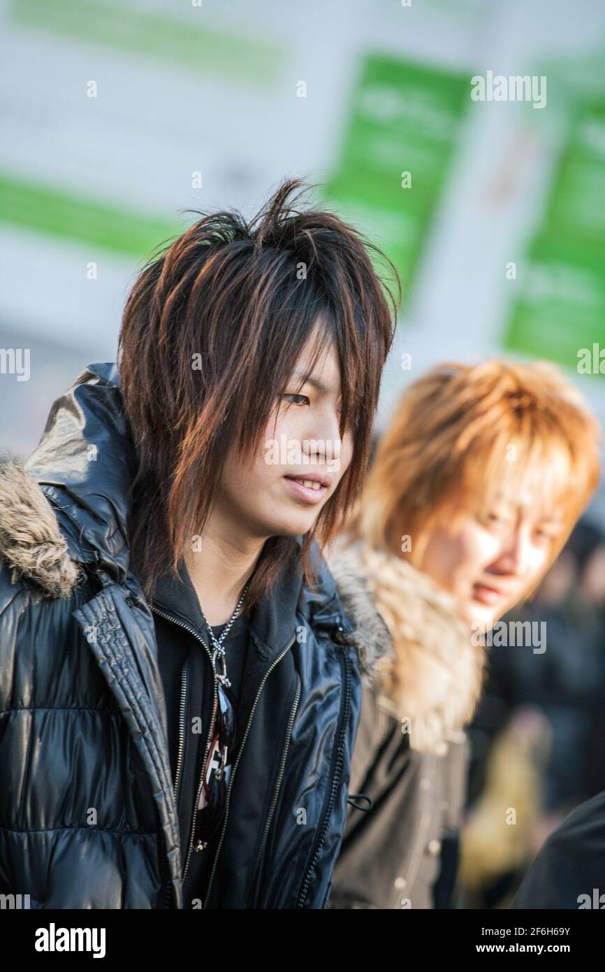 Close up of Japanese male hosts waiting for female victims to snare back to their host club outside Shibuya JR train station, Tokyo, Japan Stock Photo