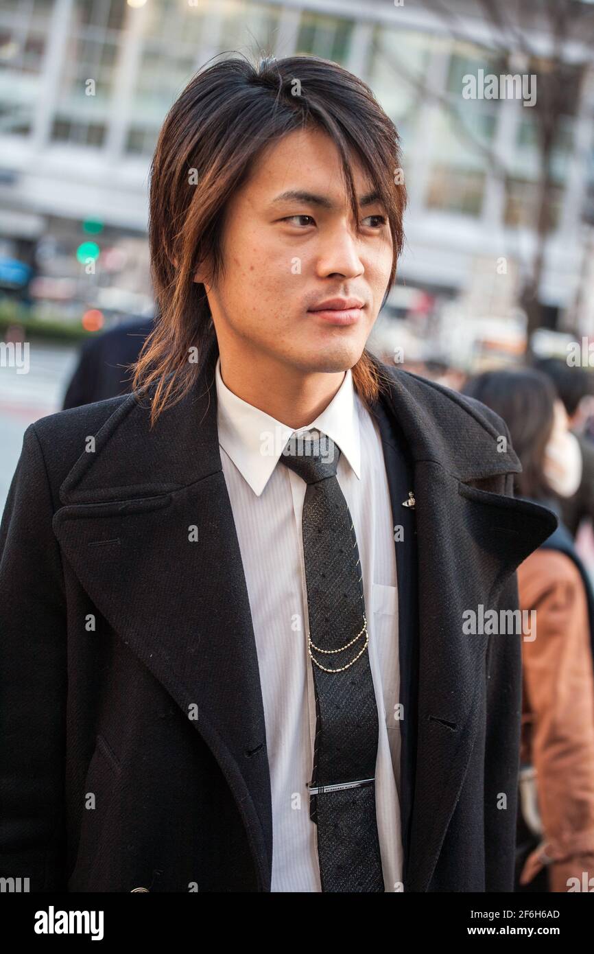 Close up of Japanese male host waiting for potential victims near Shibuya Crossing, Tokyo, Japan Stock Photo