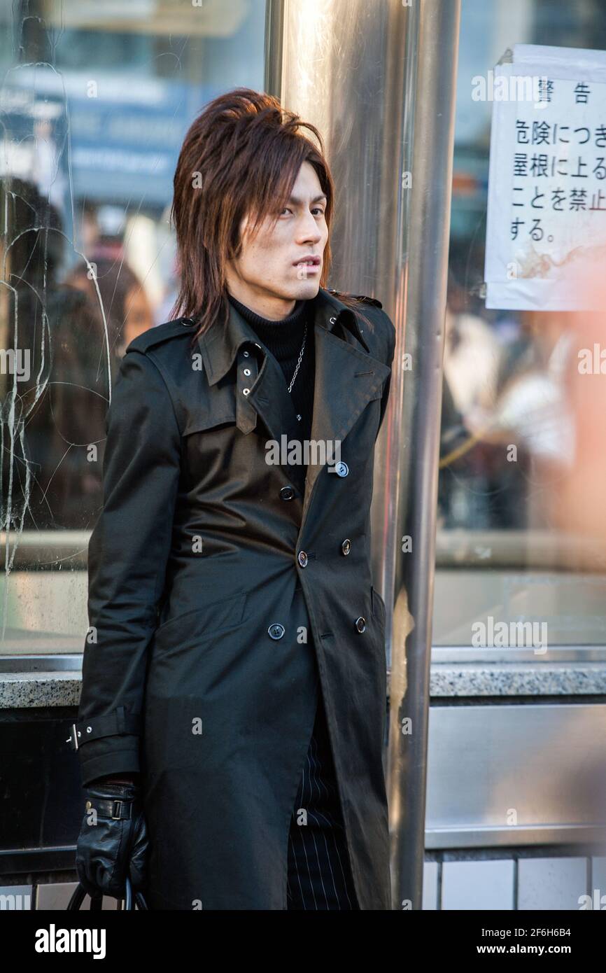 Close up of Japanese male host dressed like a rockstar hanging around near Shibuya Crossing waiting for victims, Tokyo, Japan Stock Photo