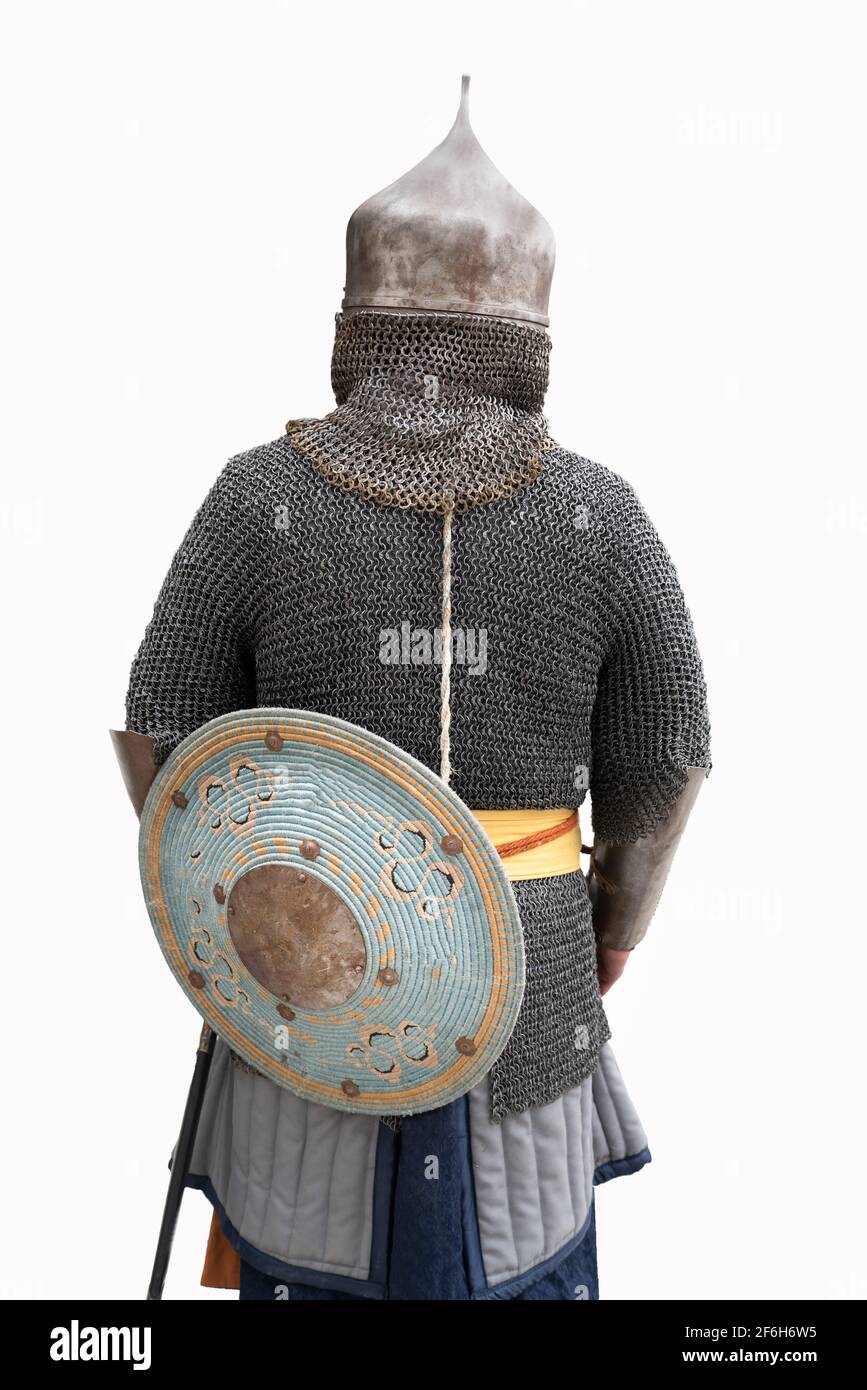 Back view of ancient Turkish soldier in metal armor in white isolated background. Stock Photo