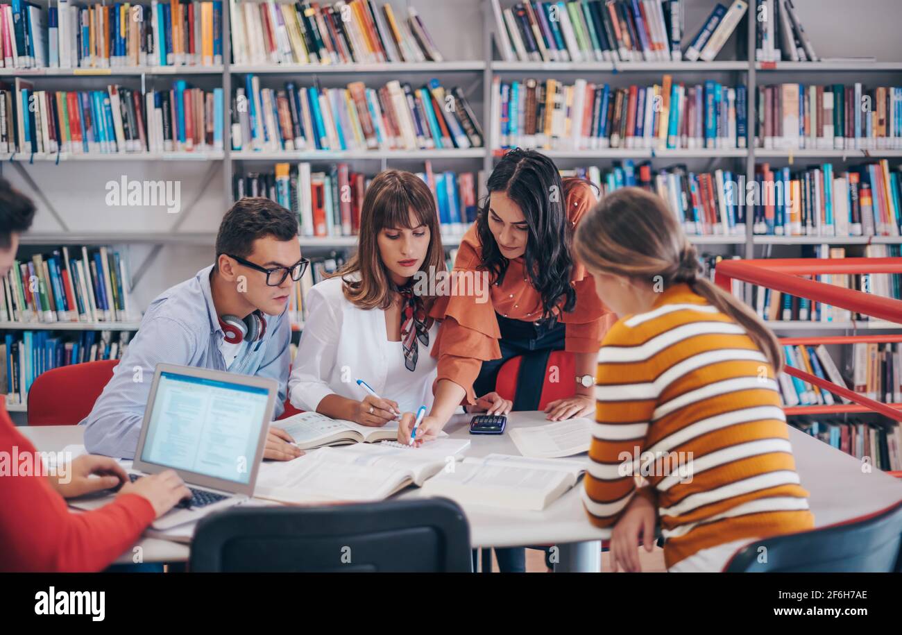 Elibrary Project For Students a group of students sit in a library and create a project for a school ...
