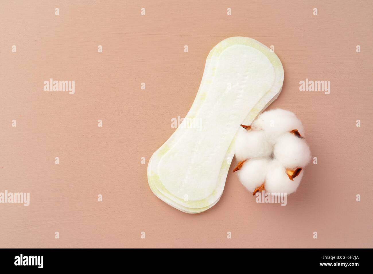 Women medical pads and cotton flower on paper background Stock Photo
