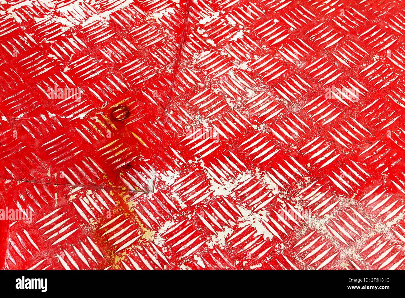 Close-up of an old red painted metal floor with patterns and rusty stains Stock Photo