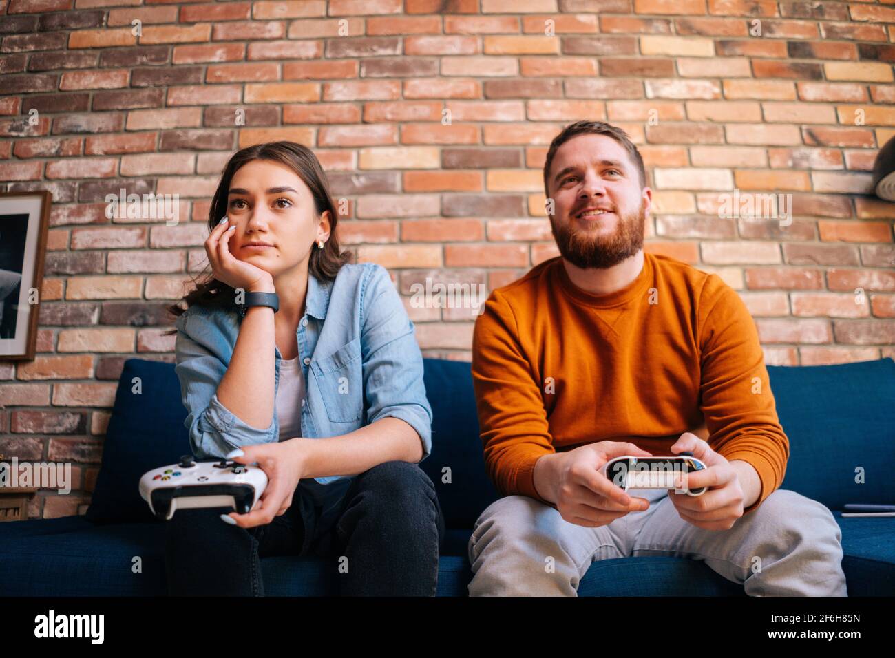 Young Cute Competitive Boyfriend Girlfriend Playing Video Games In Couch  Stock Photo, Picture and Royalty Free Image. Image 34313215.