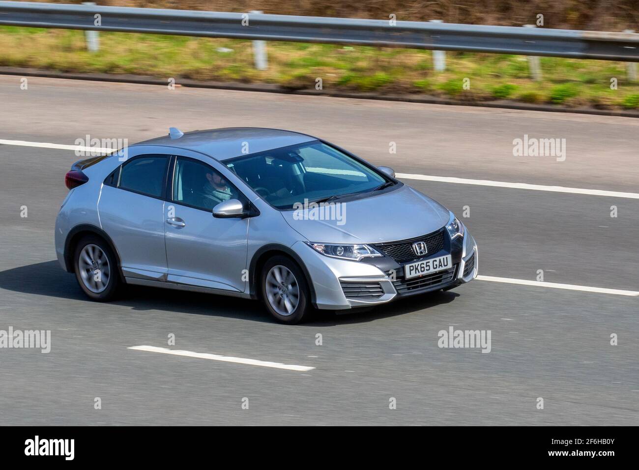 2015 15 plate silver Honda Civic I-Dtec S 1597cc diesel hatchback vehicular traffic, moving vehicles, cars, vehicle driving on UK roads, motors, motoring on the M6 highway English motorway road network Stock Photo