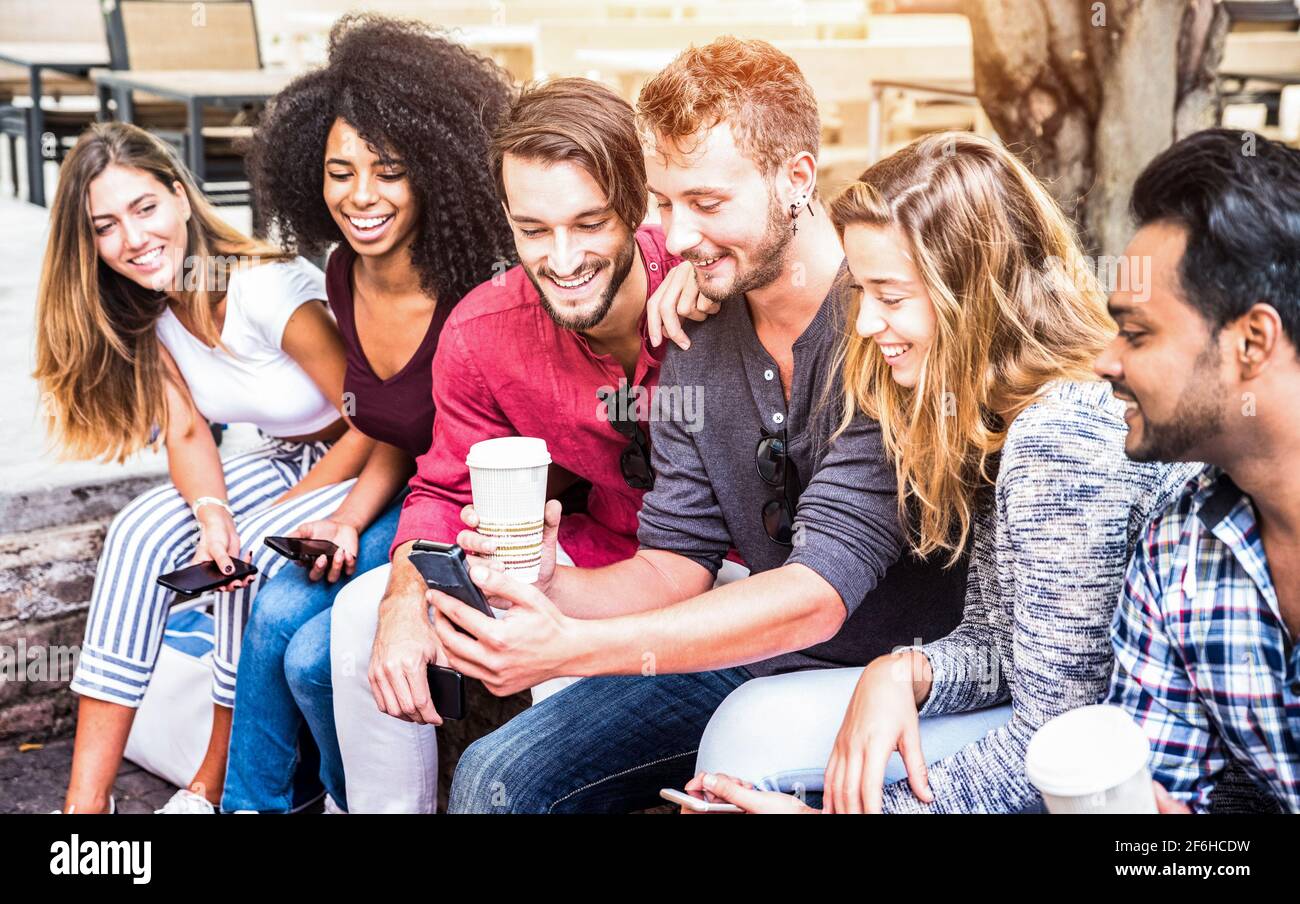 Multiracial friends group using smartphone at university college - Young people addicted by mobile smart phone - Technology concept Stock Photo