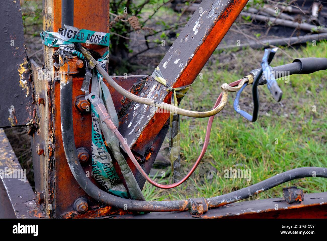 Damaged and dangerous outdoor wiring on derilict industrial site. Stock Photo
