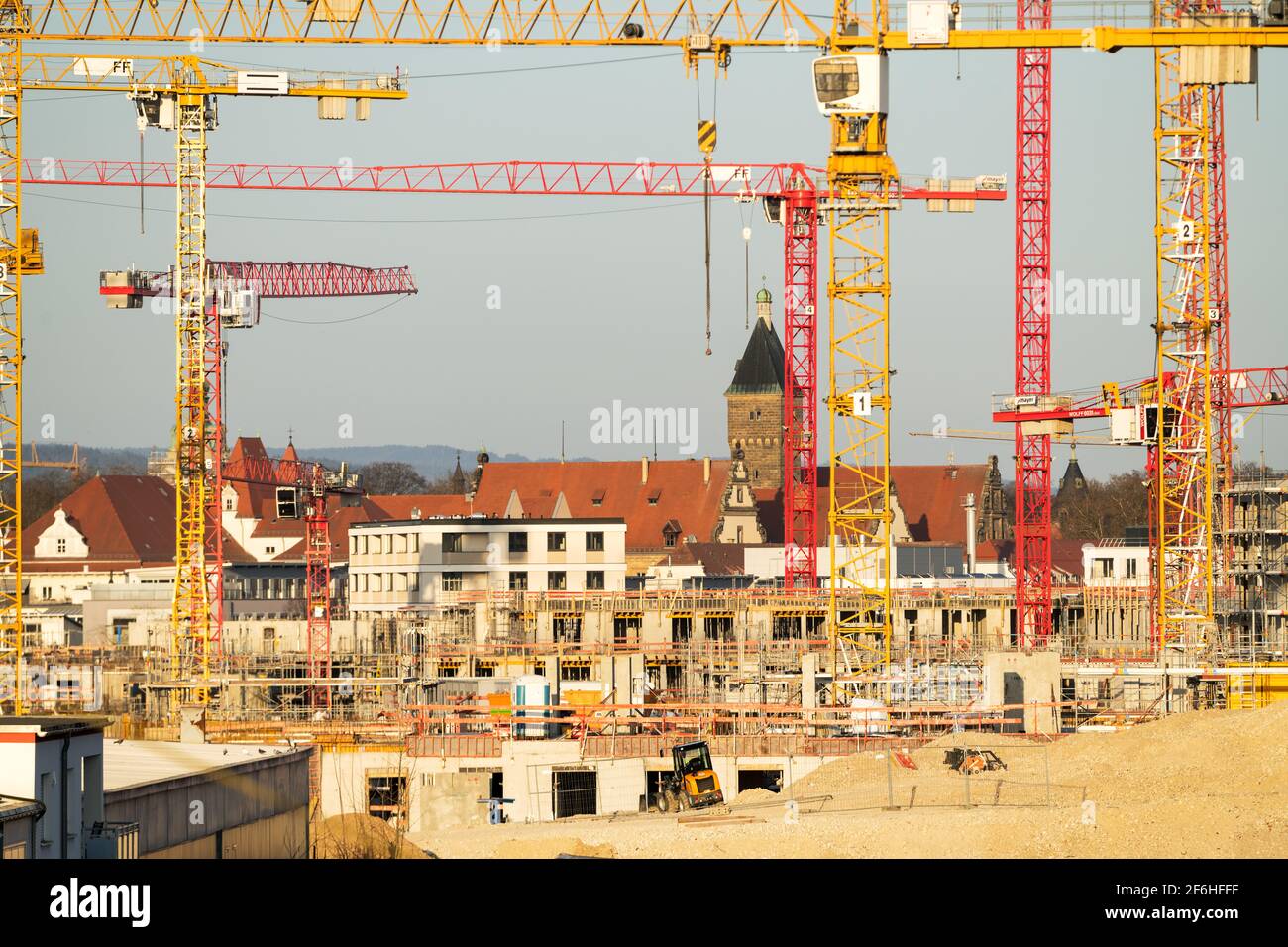 Cranes on the large construction site, a new district is being built. Major construction project. investment real estate Stock Photo
