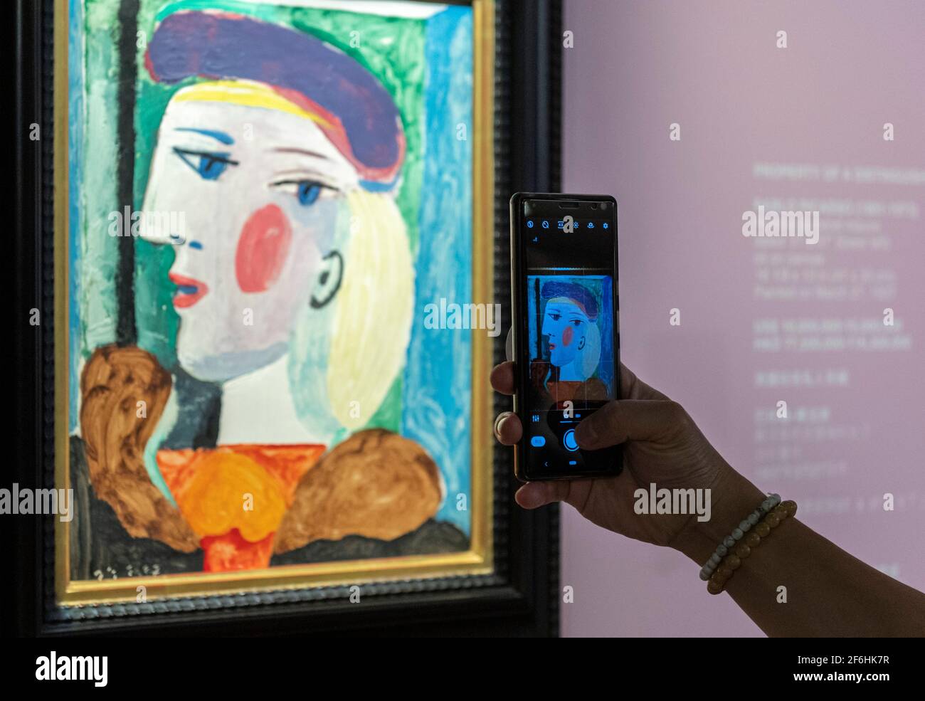 Hong Kong, Hong Kong, China. 1st Apr, 2021. Cristina Wang, specialist in Modern and Contemporary Art adjusts the Pablo Picasso' painting 'Femme au Béret Mauve'' on display at the Bonham Gallery in Admiralty Hong Kong ahead of its sale in New York in May 2021. The painting o f Picasso's greatest muse Mare-ThérÃ¨se Walter is on a world tour to attract buyers having been in London and Paris ahead of Hong Kong. A price of $15 million USD is estimated for the masterpiece. Credit: Jayne Russell/ZUMA Wire/Alamy Live News Stock Photo