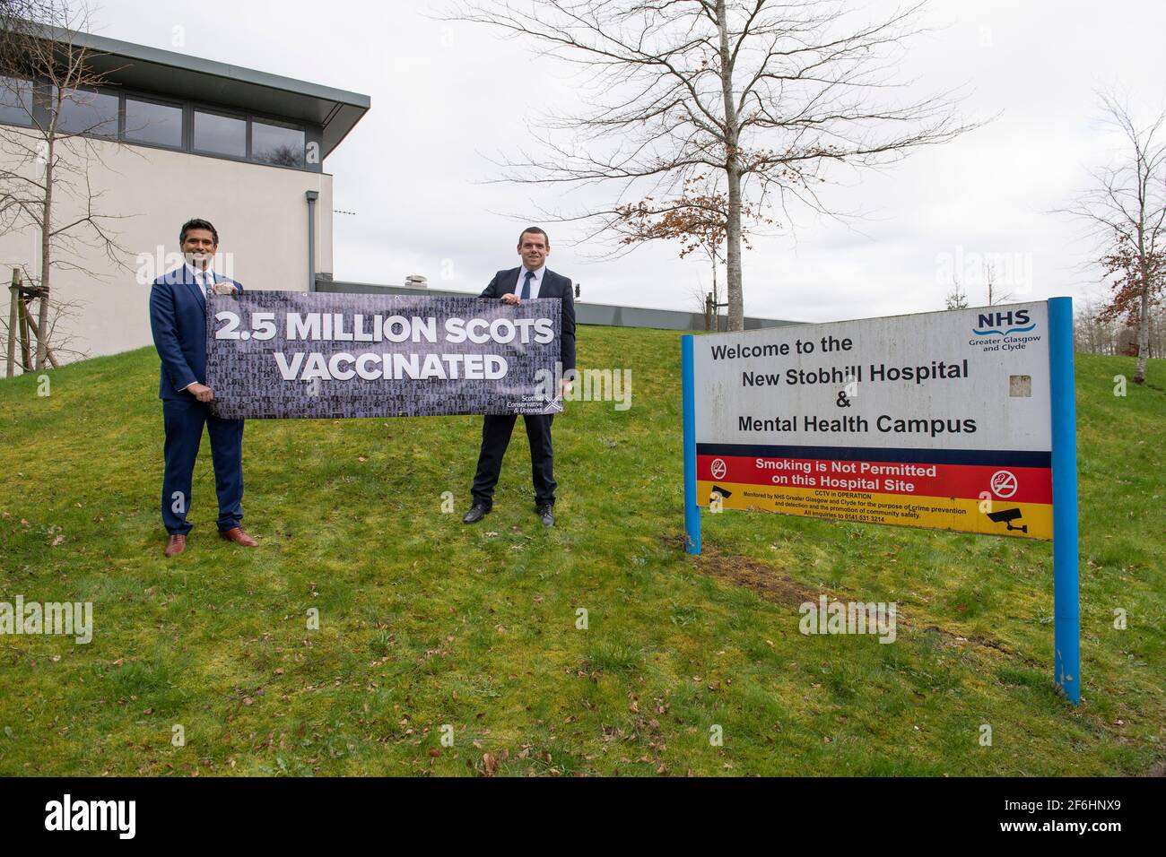 Glasgow, Scotland, UK. 1st Apr, 2021. PICTURED: (left)| Sandesh Gulhane and (right) Douglas Ross MP. Douglas Ross will meets candidate and GP Sandesh Gulhane to unveil a banner on the vaccine rollout and announce the party's NHS spending pledges. Pic Credit: Colin Fisher/Alamy Live News Stock Photo