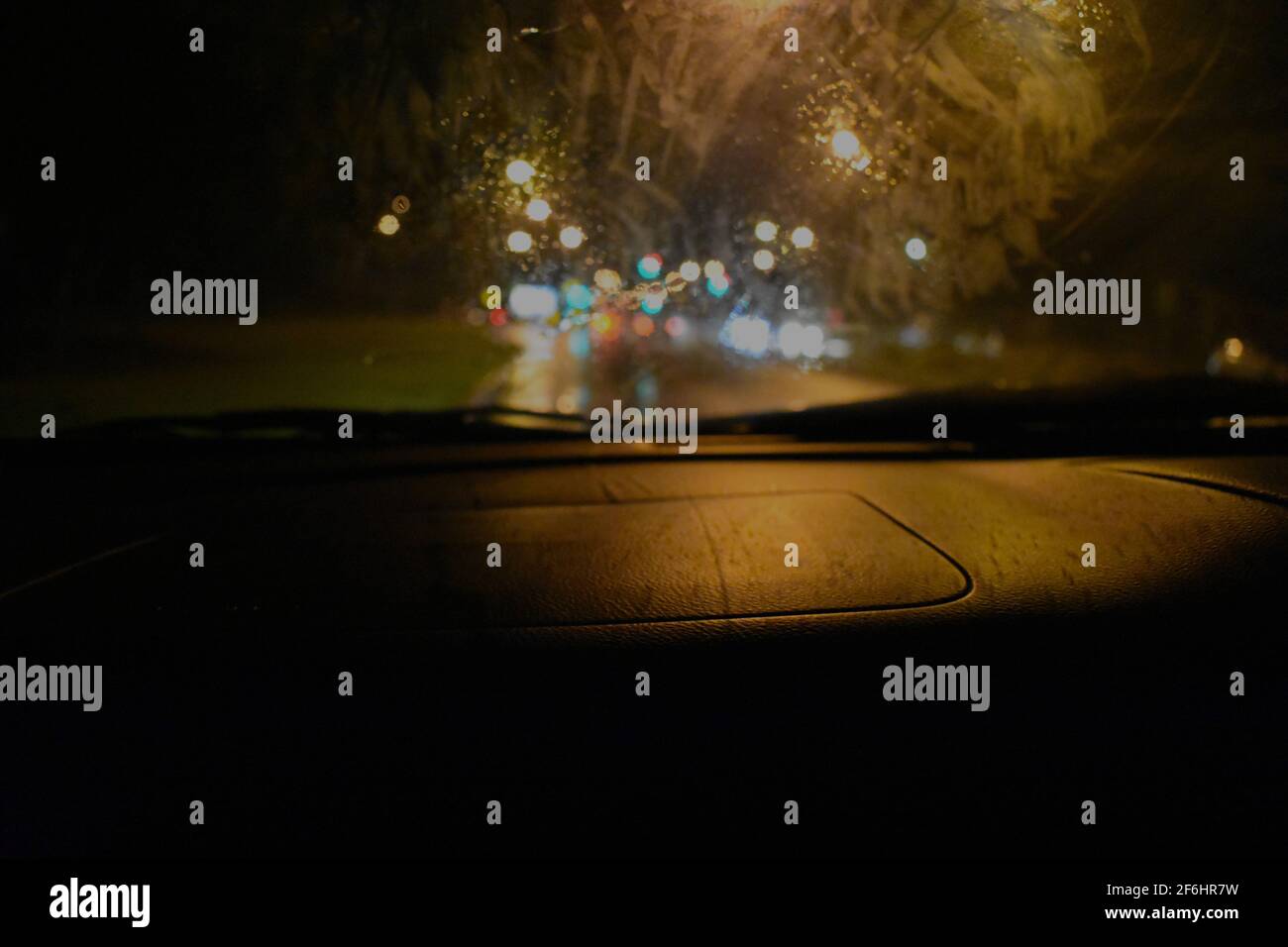 the blurred lights coming from car headlights and signals while driving through the rainy night. Taken during the floods of  March 2021 in Sydney Stock Photo