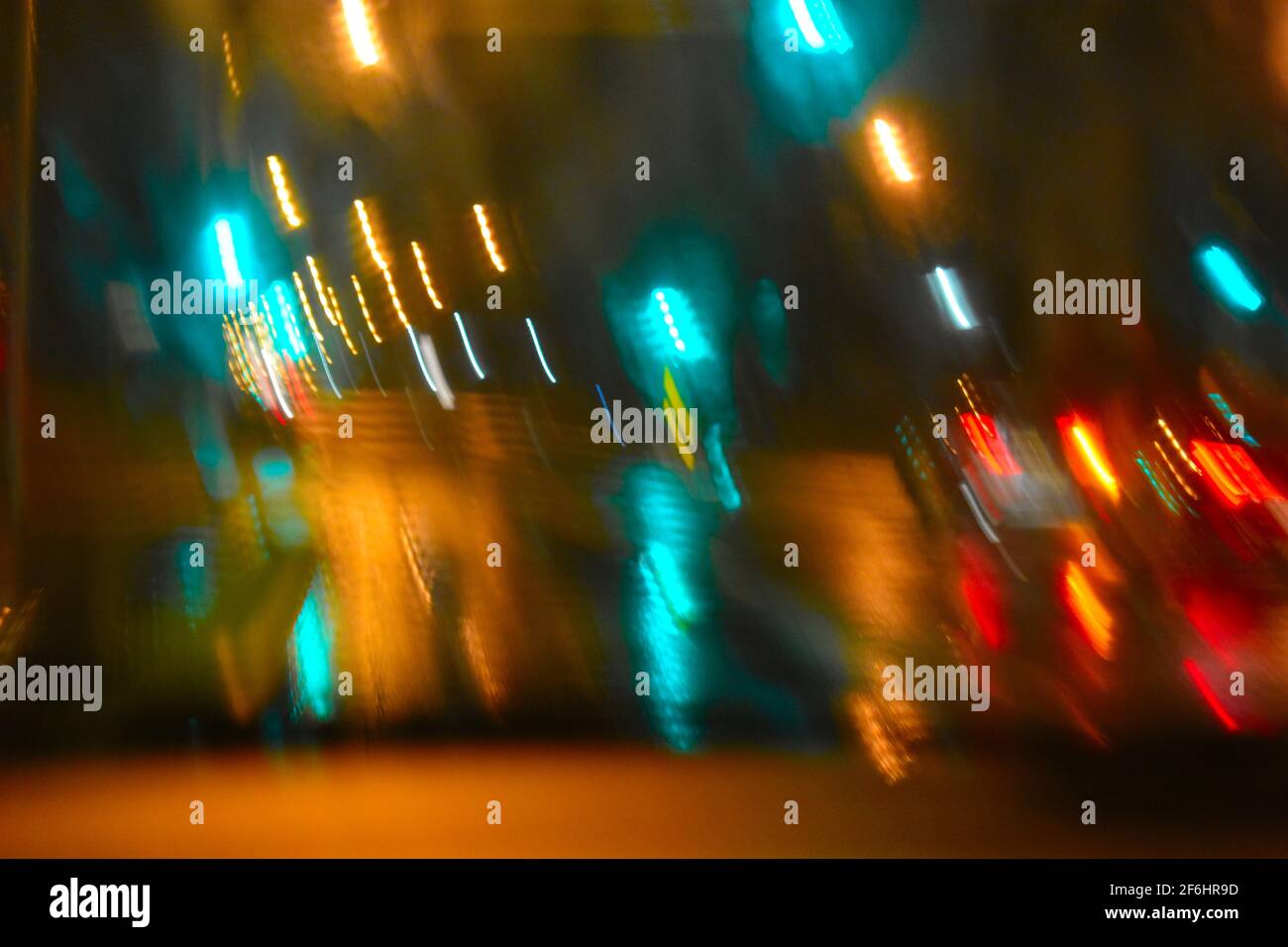 the blurred lights coming from car headlights and signals while driving through the rainy night. Taken during the floods of  March 2021 in Sydney Stock Photo