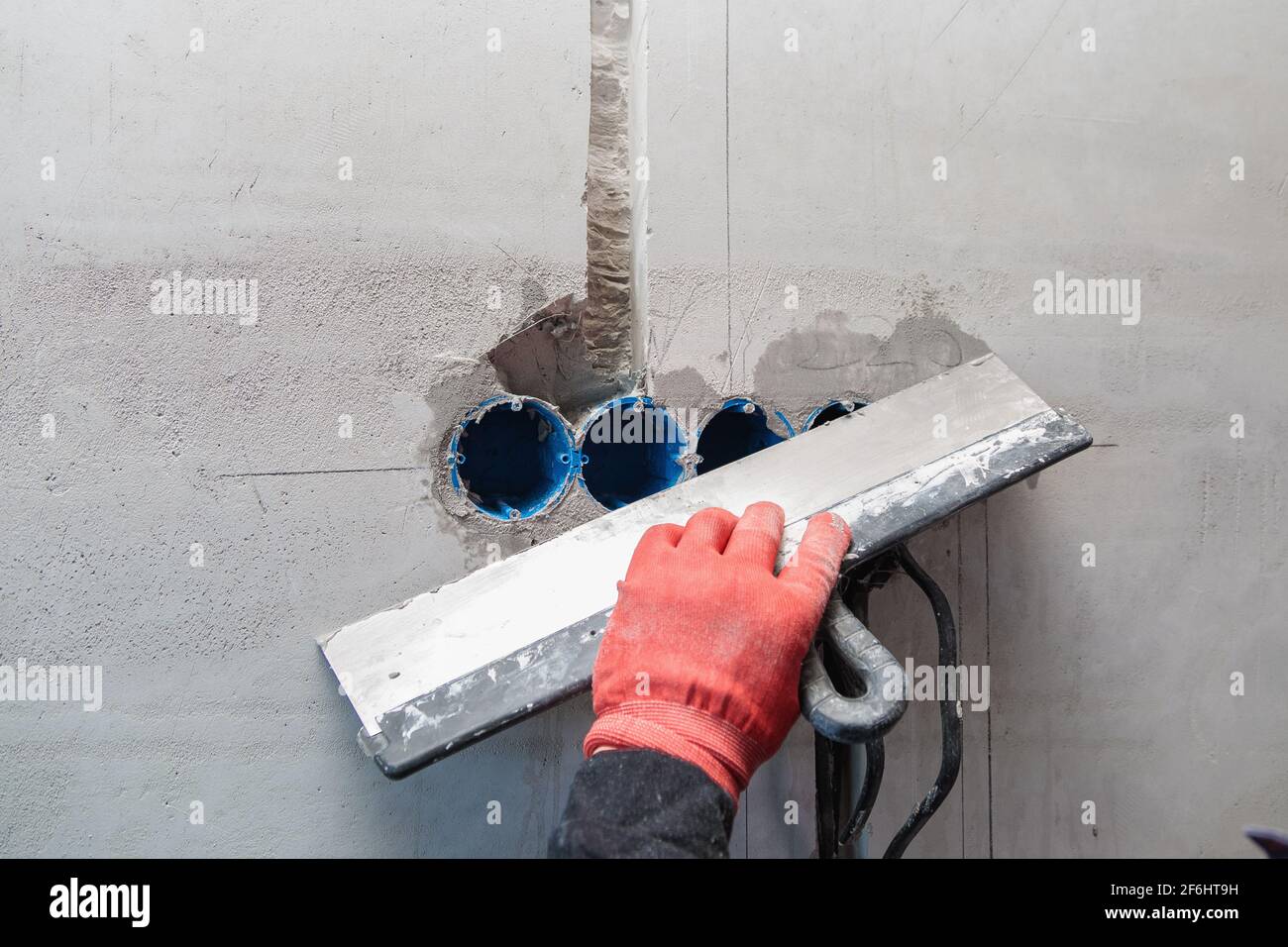 The electrician will plaster holes and channels for sockets and wires