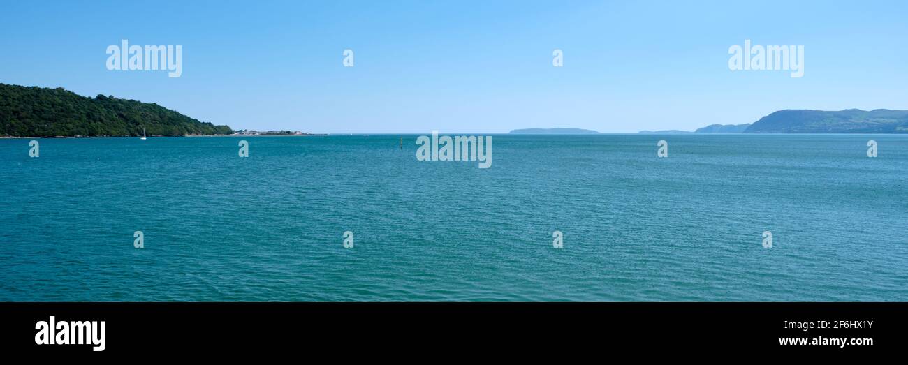 A panorama of the Eastern end of the Menai Strait from Beaumaris to Penmaenmawr, Wales from the Bangor Pier Stock Photo