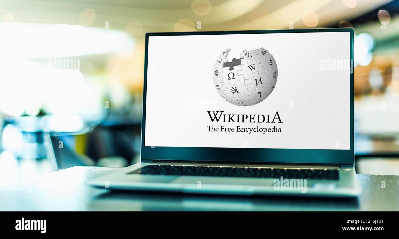 POZNAN, POL - FEB 6, 2021: Laptop computer displaying logo of Wikipedia, multilingual, web-based, free encyclopedia, owned and supported by the Wikime Stock Photo