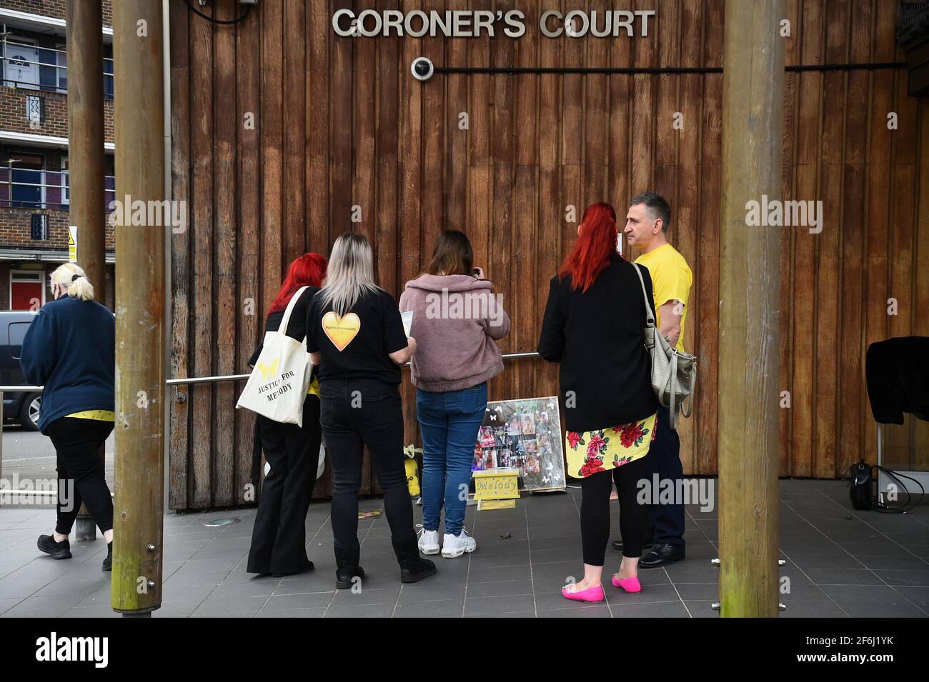 Nigel and Karina Driscoll, the parents of Melody Driscoll, and family look at tributes outside Southwark Coroner's Court, London, following the inquest into their daughter's death. The seriously ill 11-year-old girl who had a "complicated medical history" died after suffering complications following an operation for gallstones, a coroner has said. Picture date: Thursday April 1, 2021. Stock Photo