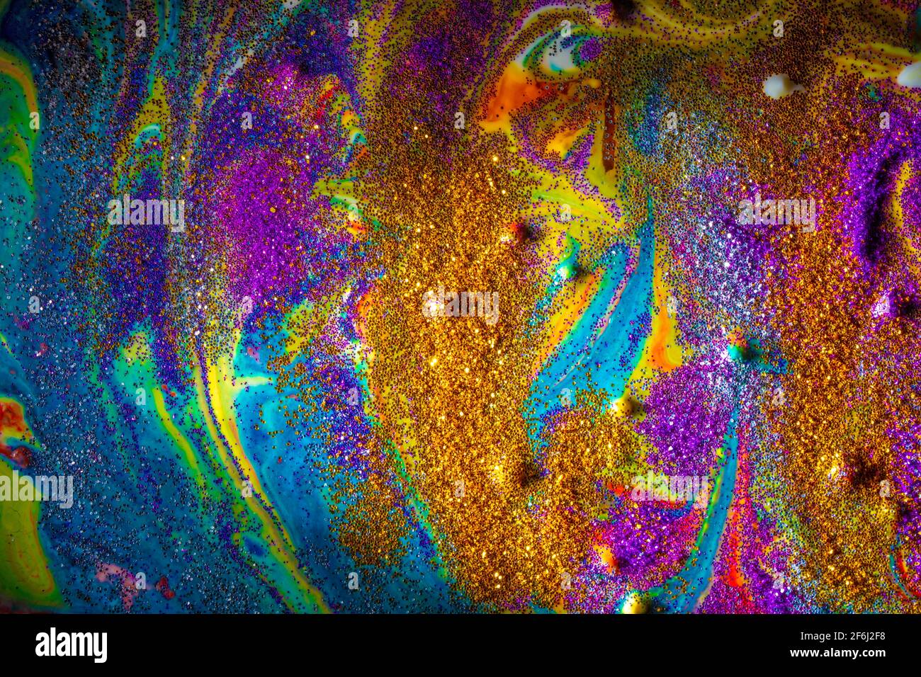 Multicolored acrylic background with curls sprinkled with purple and gold sparkles. Contemporary creativity. A colorful avant-garde painting with rich Stock Photo
